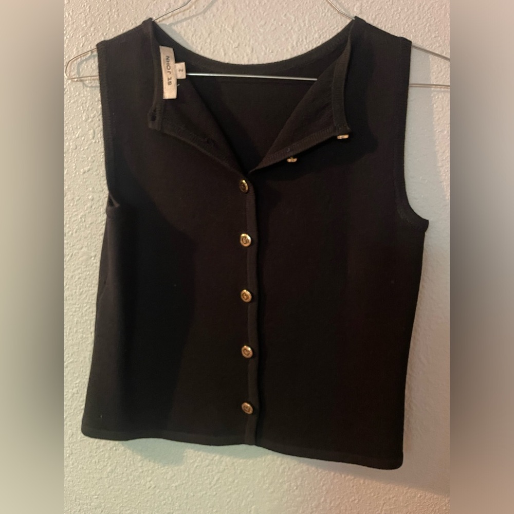 Black sleeveless knit top with gold buttons down the back